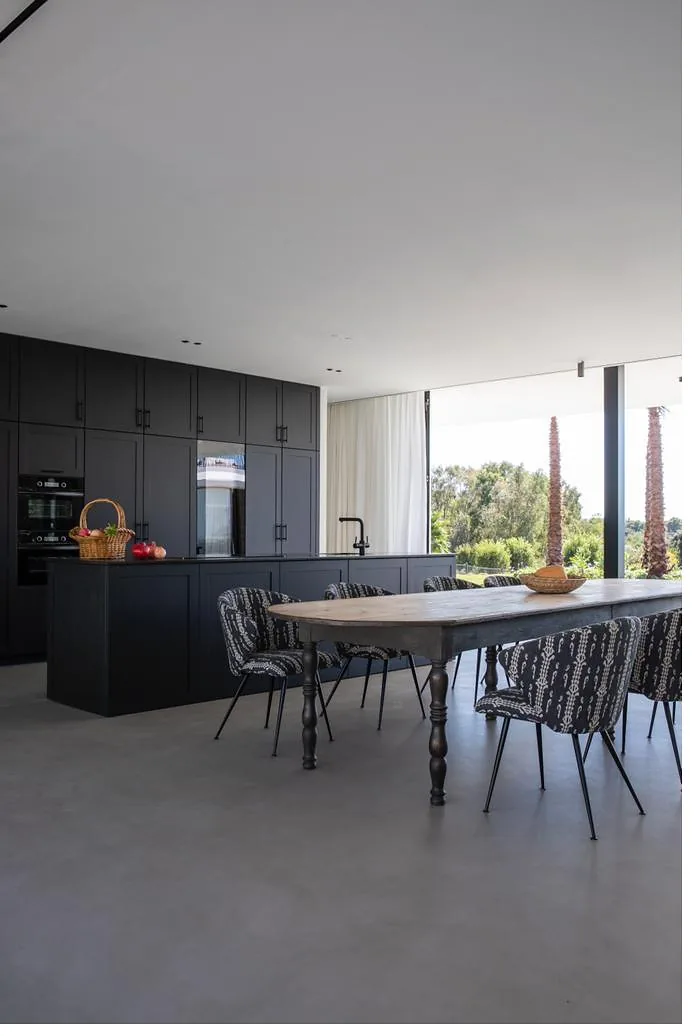 Cocina de diseño en color grafito integrada con la zona de comedor